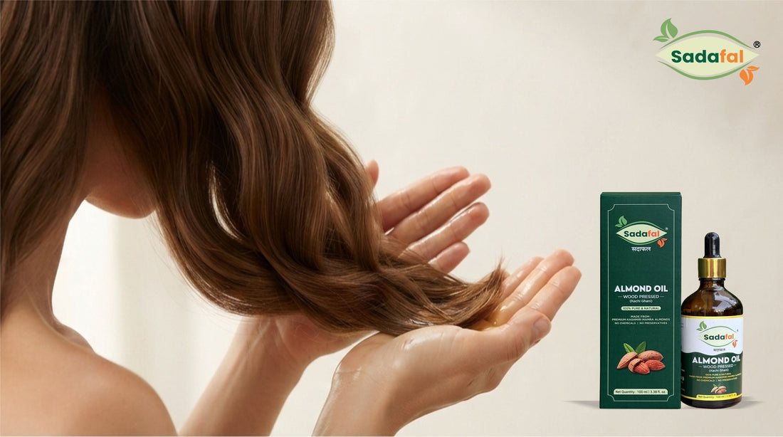 Woman smoothing Sadafal Almond Oil through hair ends to control frizz